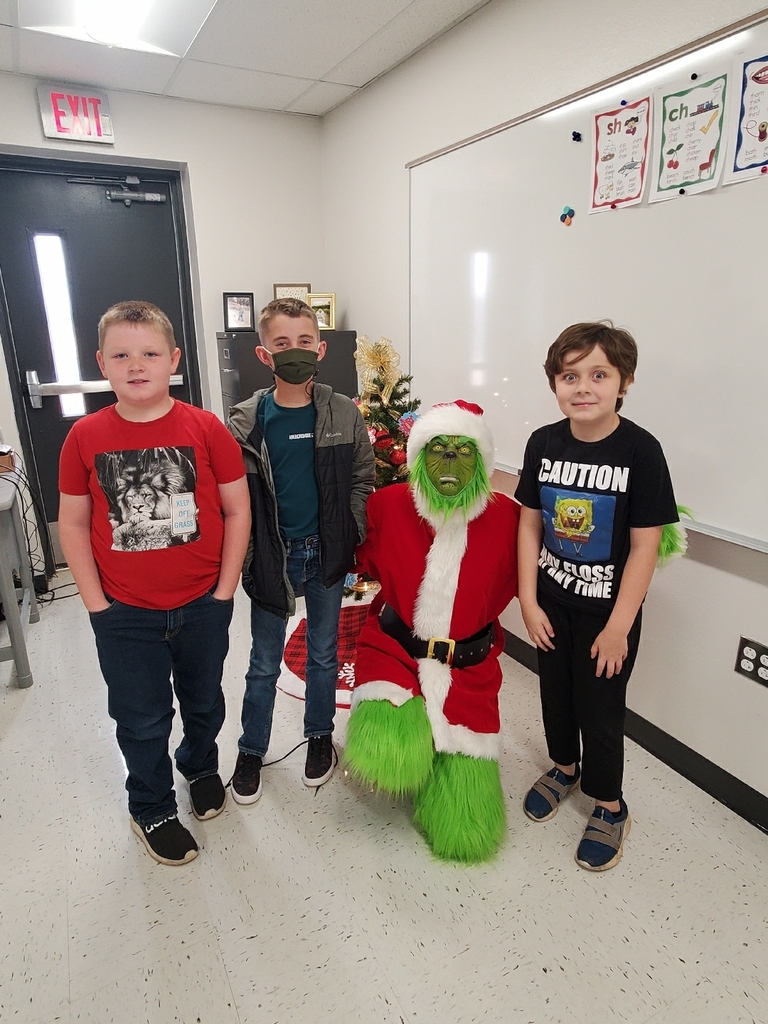 The Grinch posed for a picture with some 3rd graders.
